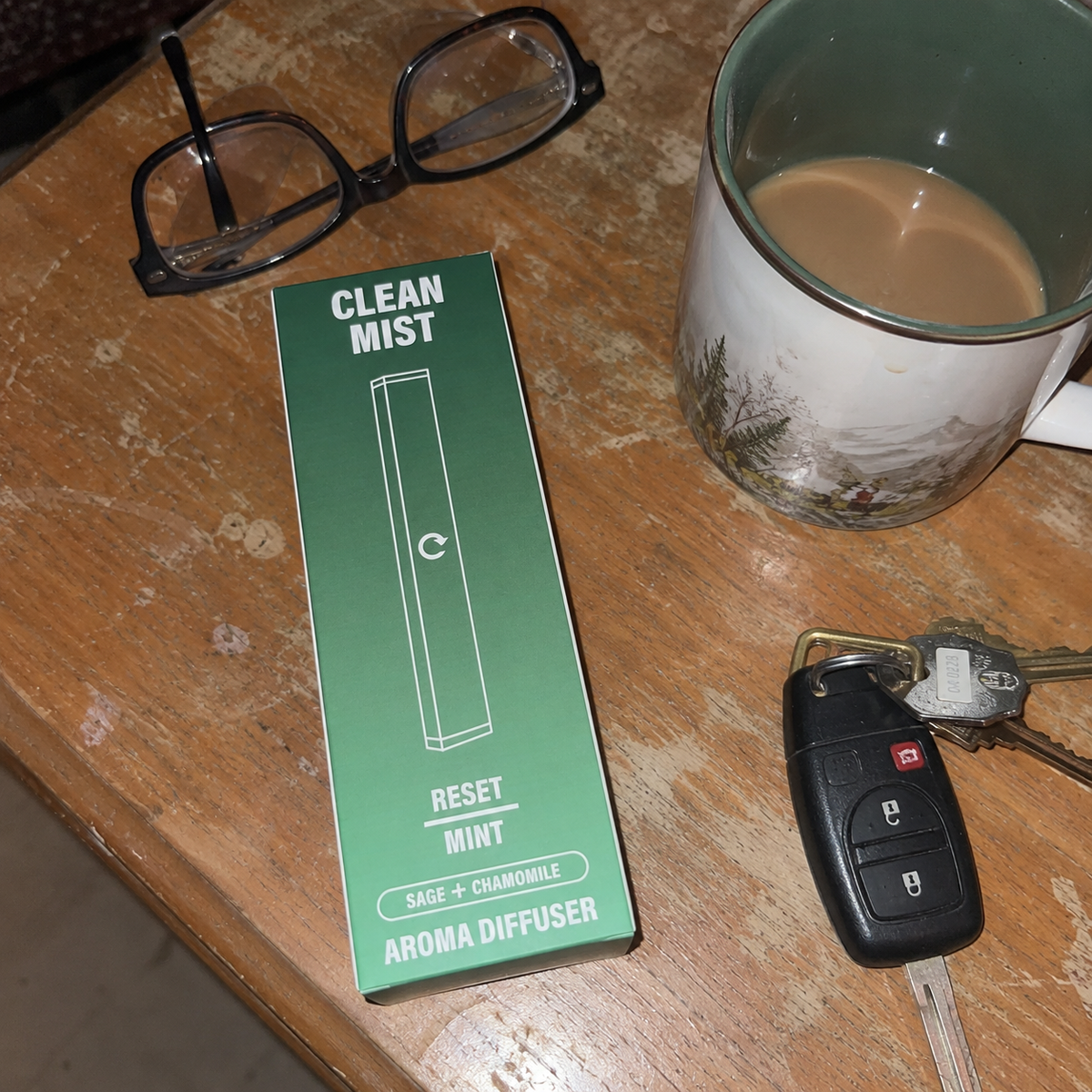 A CleanMist Reset box next to a mug of coffee and car keys